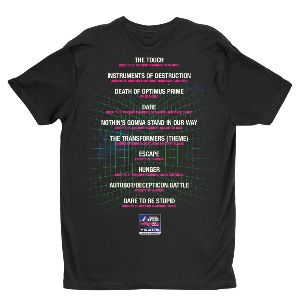 A black short-sleeve t-shirt with a back graphic listing various movie and TV show titles in white text, highlighted by pink and green accents over a grid pattern, with a Transformers logo at the bottom.